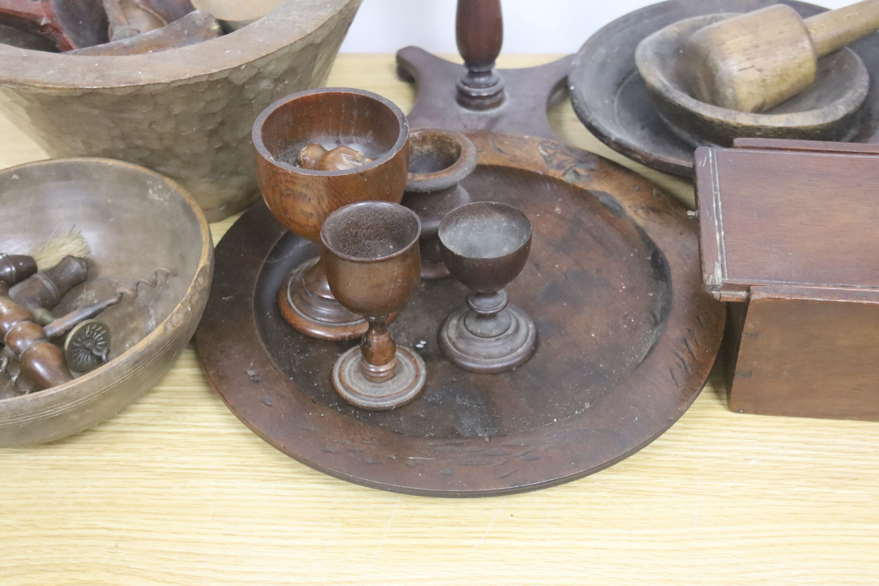 A group of assorted treen including an 18th century sliding lid mahogany box, a candle stand and various goblets etc.